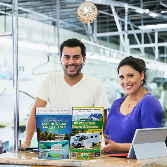 Two people standing behind a counter with various products, including a box labeled 'Vegetable and Fruit Cleaner'.