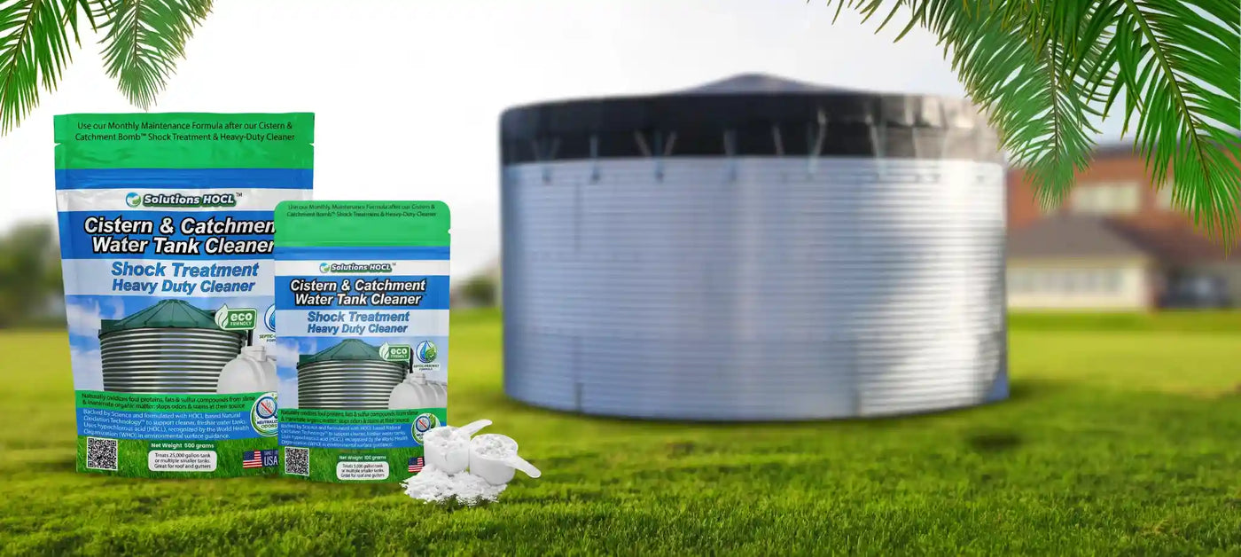 Water tank cleaner products in front of a large metal water tank on grass.