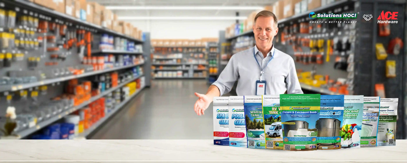 Man holding a product display in a hardware store with shelves and products in the background