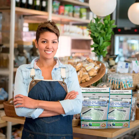Woman standing in a store with Cold Plunge products displayed