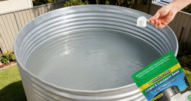 Person using a water softening product on a large metal tank outdoors